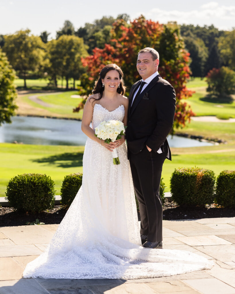 Bride and groom overlooking the golf course at Glen Head Country Club. 