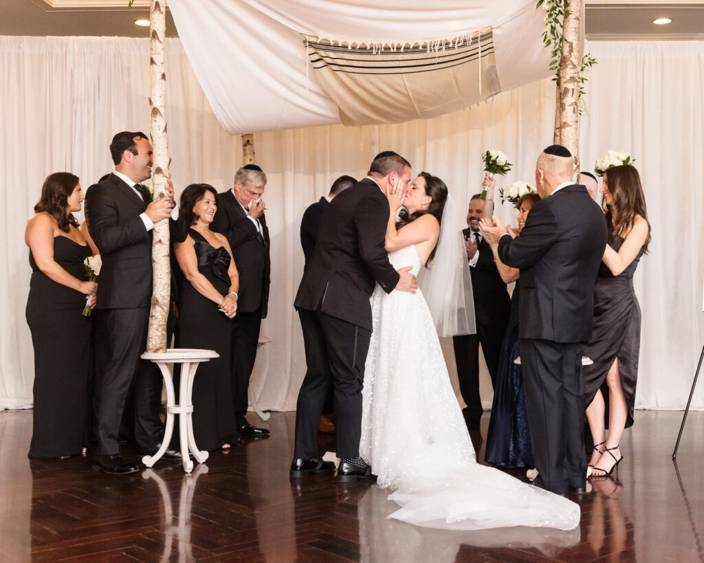 Bride and groom kissing at Glen Head Country Club.