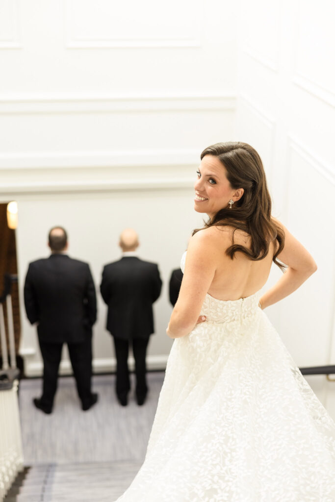 Bride looking back over her shoulder at Glen Head Country Club. 