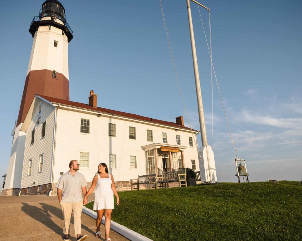 Couple walking away from Montauk Lighthouse. 