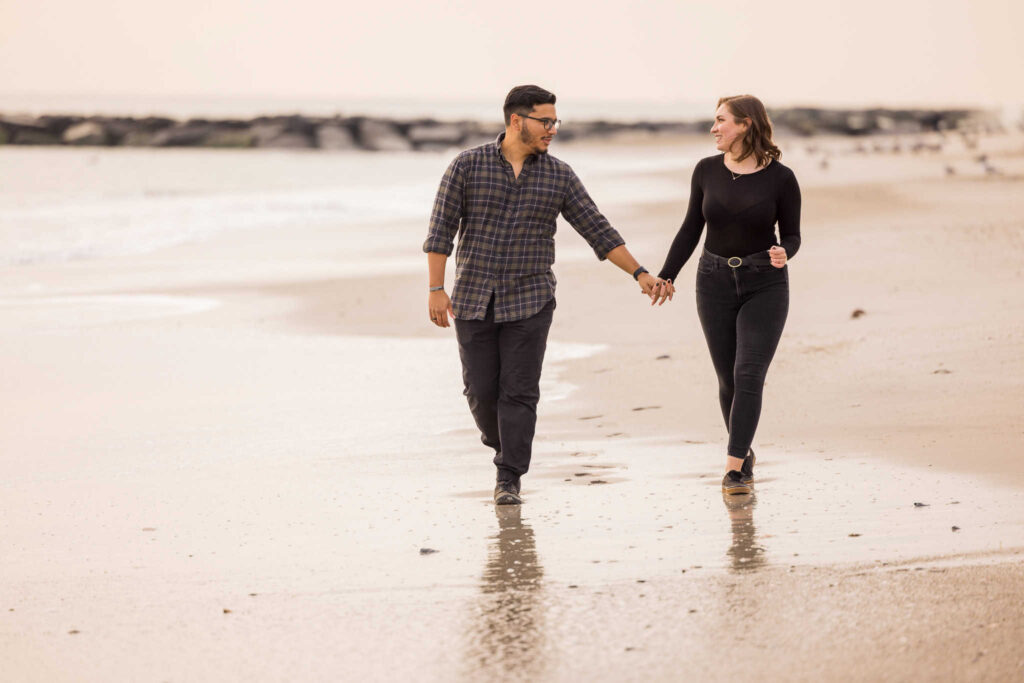 Couple holding hands on Long Beach.