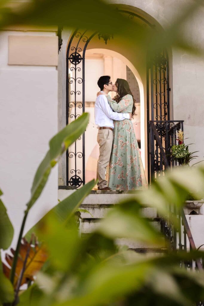 Couple kissing in doorway at Vanderbilt Museum. 