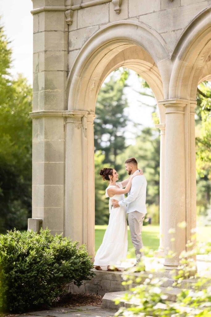 Couple dancing in archway at Planting Fields Arboretum