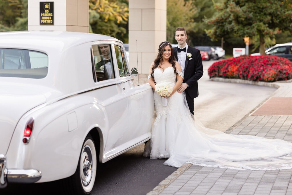 Bride and groom next to Rolls Royce at the Garden City Hotel.