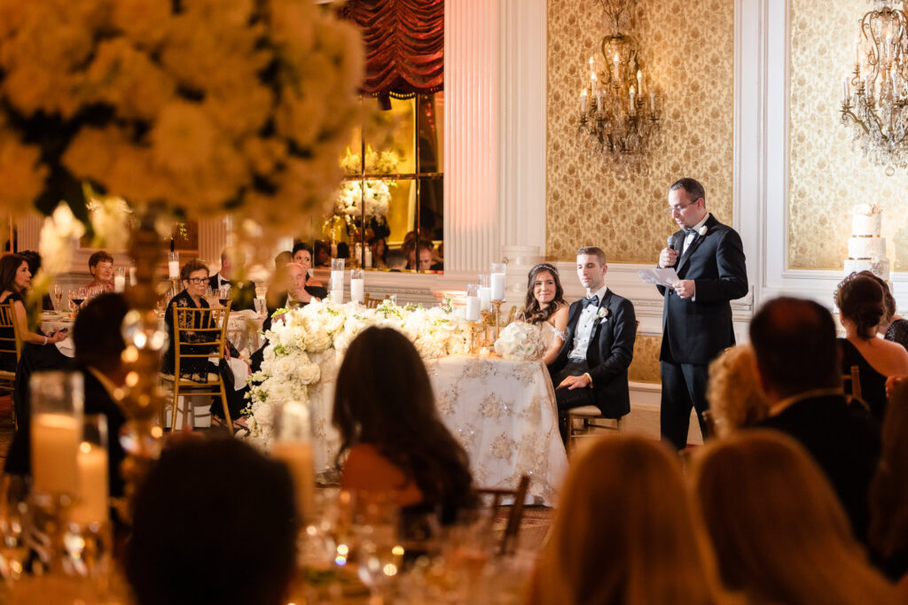 The best man giving a speech at the Garden City Hotel. 