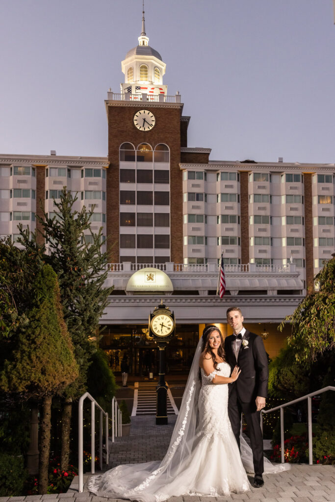 Bride and groom in front of the Garden City Hotel. 