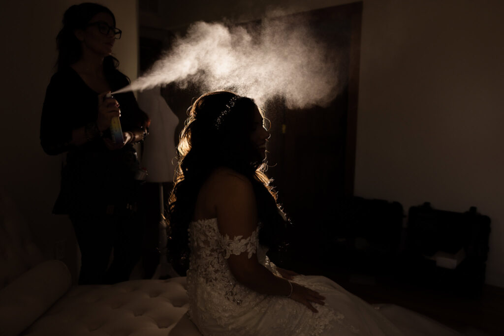 Hairspray shot of bride in silhouette.