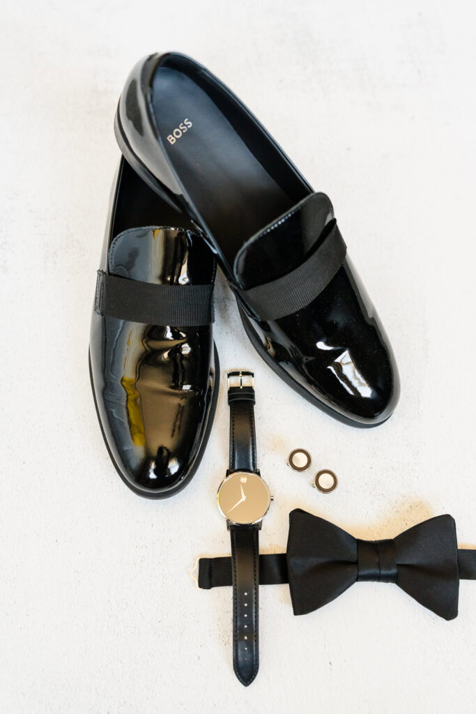 Detail images of groom's shoes, cufflinks, bowtie, and watch. 