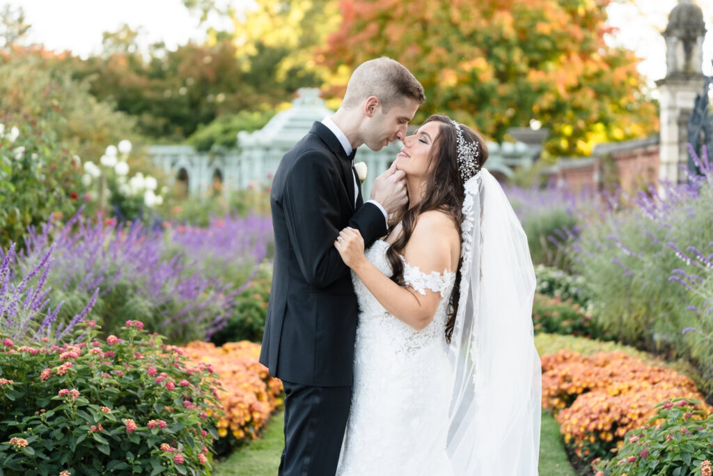 Bride and groom about to kiss at Old Westbury Gardens.