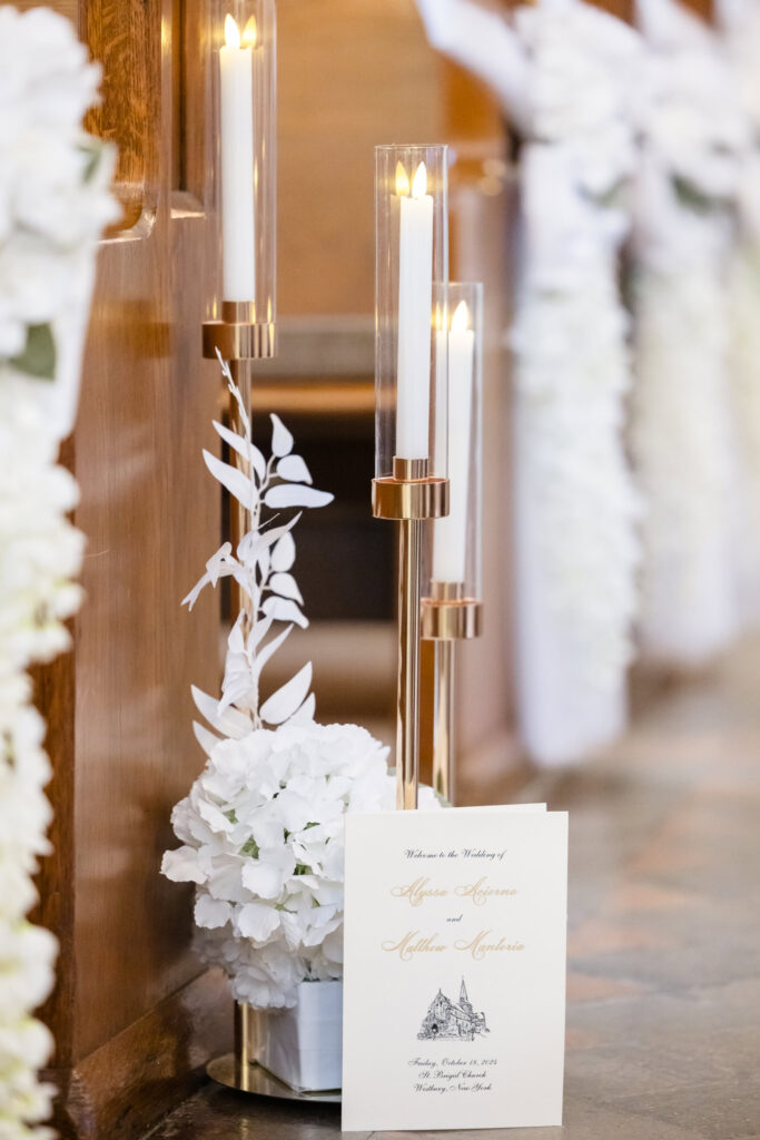 White flowers and candles from Pew Bow Rentals at church with the program at St. Brigid's church.