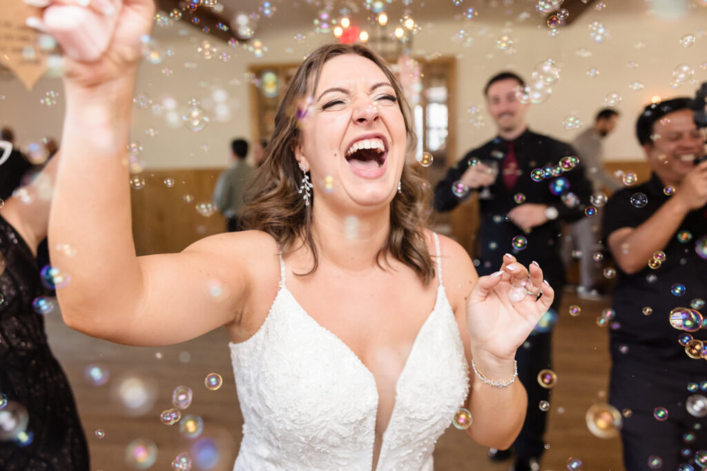 Bride dancing while surrounded by bubbles at The Vineyard at East Wind Long Island. 