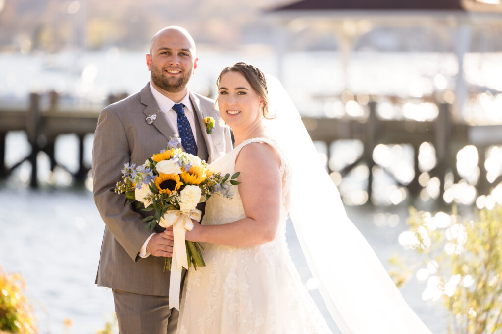 Bride and groom smiling at the camera at Northport Park.