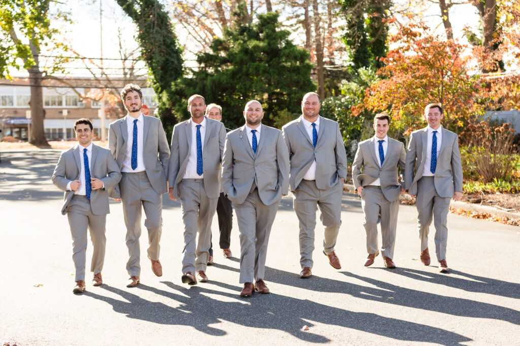 Groom and groomsmen walking on the street.