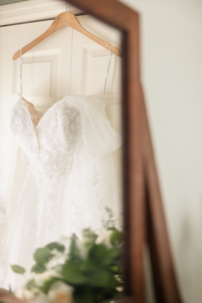 Bride's dress reflected in mirror.