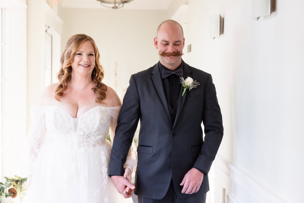 Bride and groom holding hands before first look at Stewart Manor Country Club wedding.