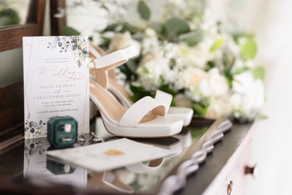 Bride's shoes, invitations, and rings.