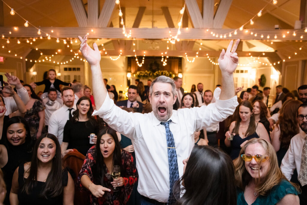 Guest cheering at the Stewart Manor Country Club wedding reception. 