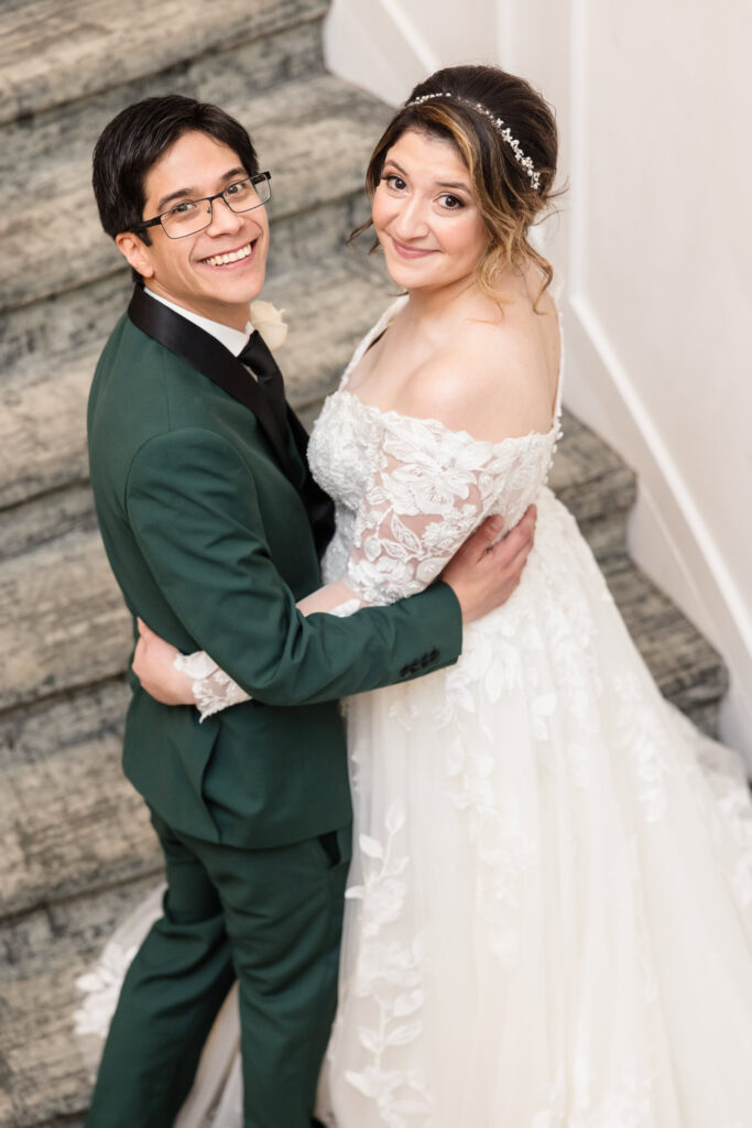 Bride and groom on the staircase at Water's Edge.