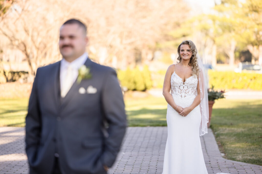 Bride looking at the groom before the first look. 