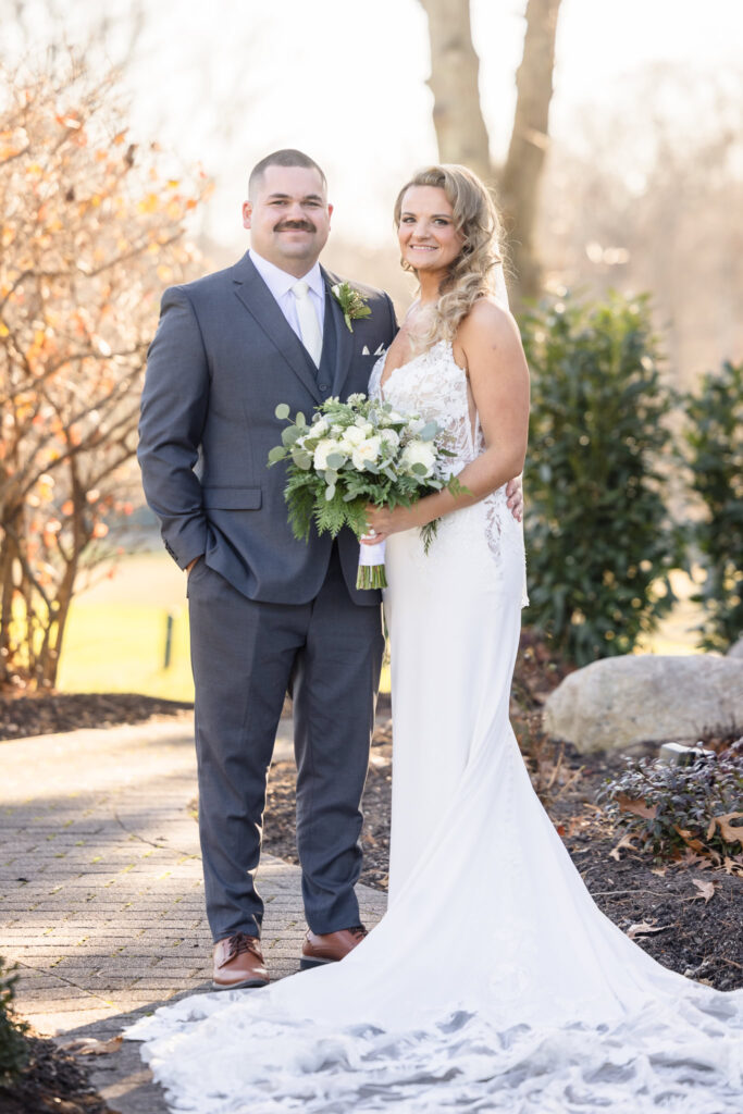 Full length image of bride and groom looking at the camera. 