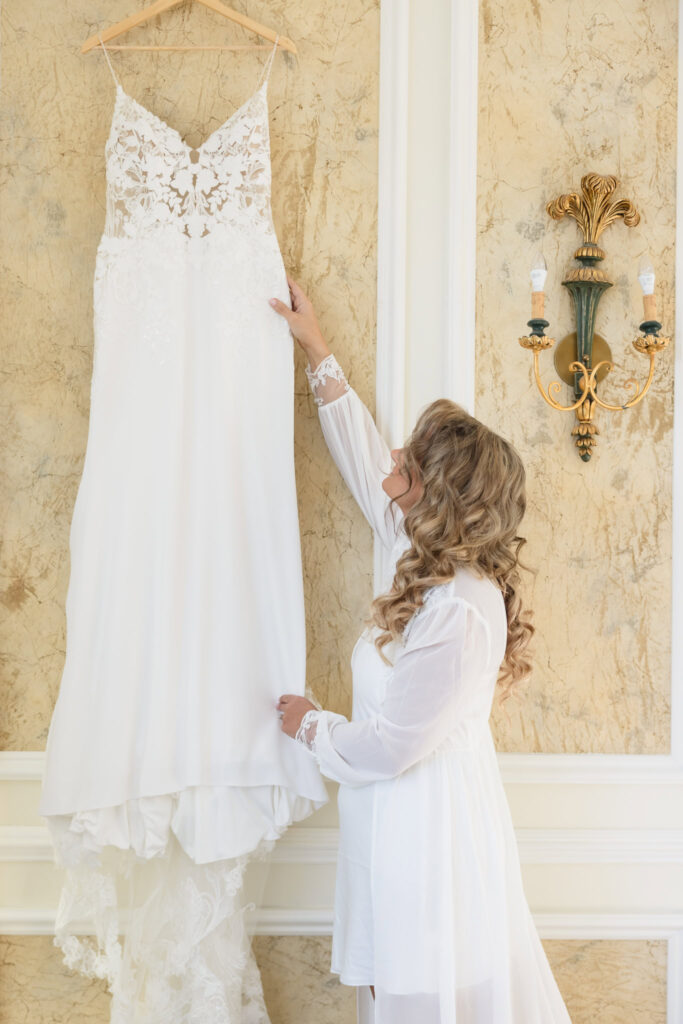 Bride taking getting her dress ready at the bridal suite at Stonebridge Country Club. 
