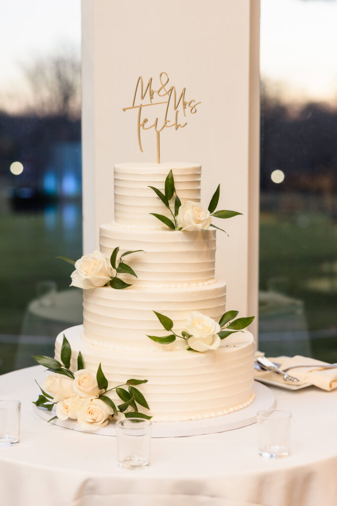 Wedding cake decorated with white flowers. 