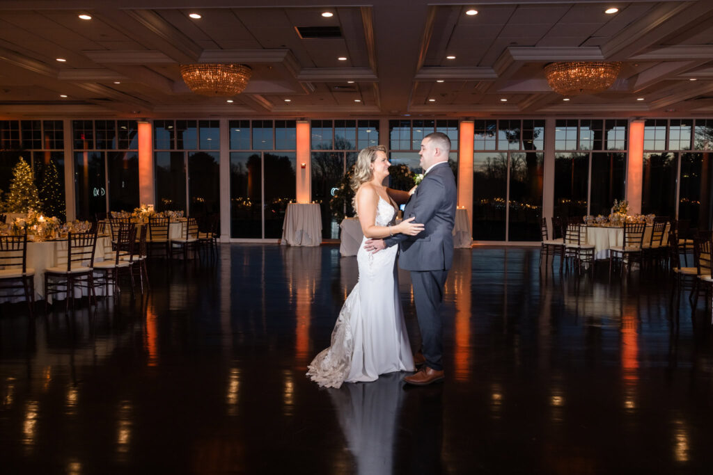 Bride and groom on the dance floor dancing privately before the reception begins. 