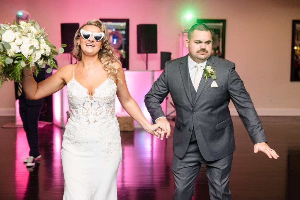 Bride and groom dancing while entering reception at Stonebridge Country Club.