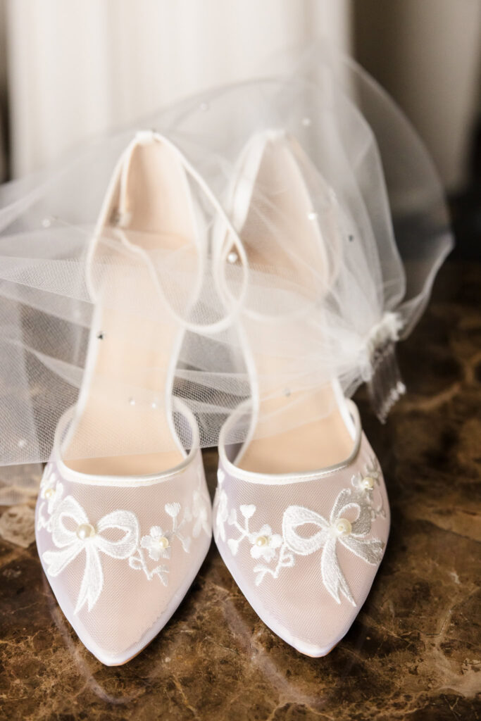 Bride's shoes with wedding veil at Inn at Great Neck.