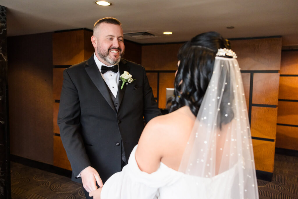 Groom seeing bride for the first time at the Inn at Great Neck.
