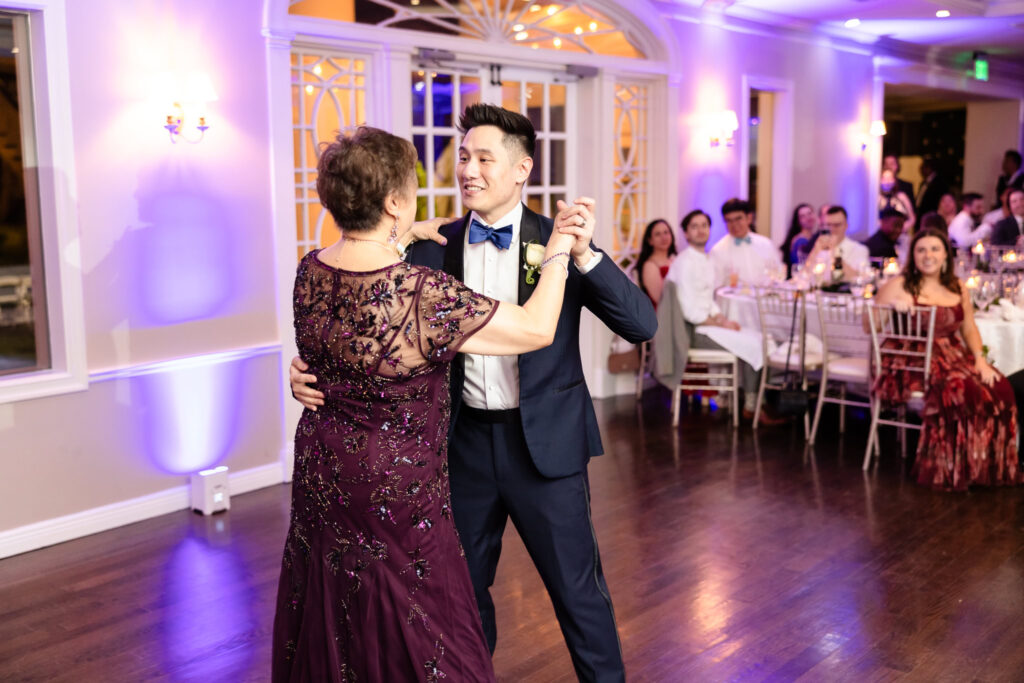 Groom dancing with his mother during a heartfelt parent dance at the wedding reception.