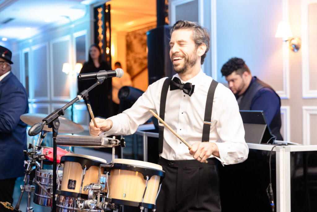 Live percussionist smiling while performing during the wedding reception at The Briarcliff Manor.

