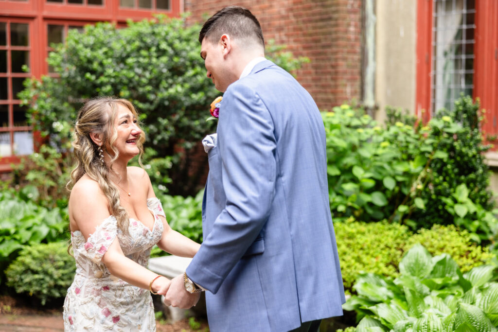 Bride and groom laughing during emotional first look at Coindre Hall