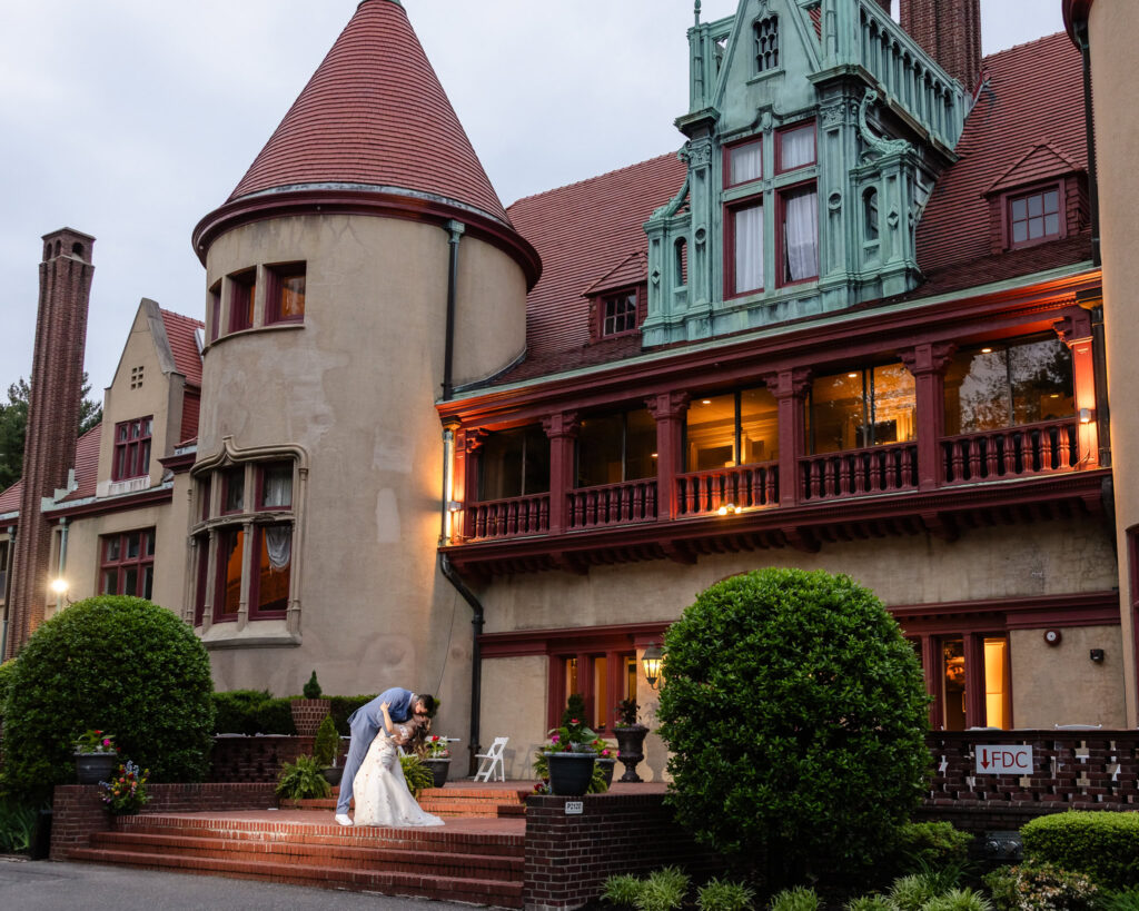 Couple walking hand in hand under twilight glow of Coindre Hall