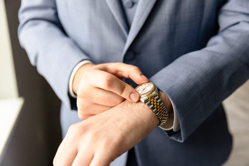 Groom fastening his watch, moments before the first look at Coindre Hall