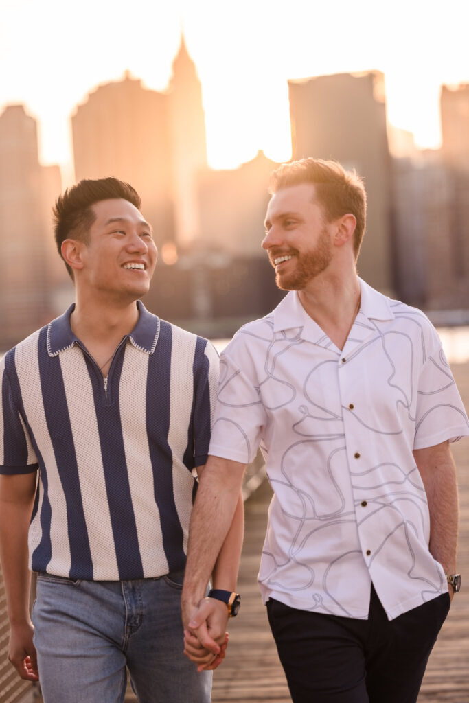 Walking closely together at sunset, the couple exchanges a warm look, completely at ease in each other’s presence.