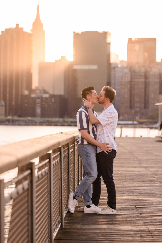 Leaning into one another on the boardwalk rail, Dave and Peter pause to take in the skyline, surrounded by soft, fading light.