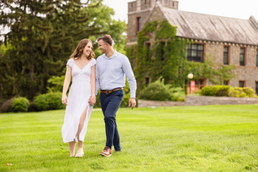 Couple walking through lush green lawn at Marist