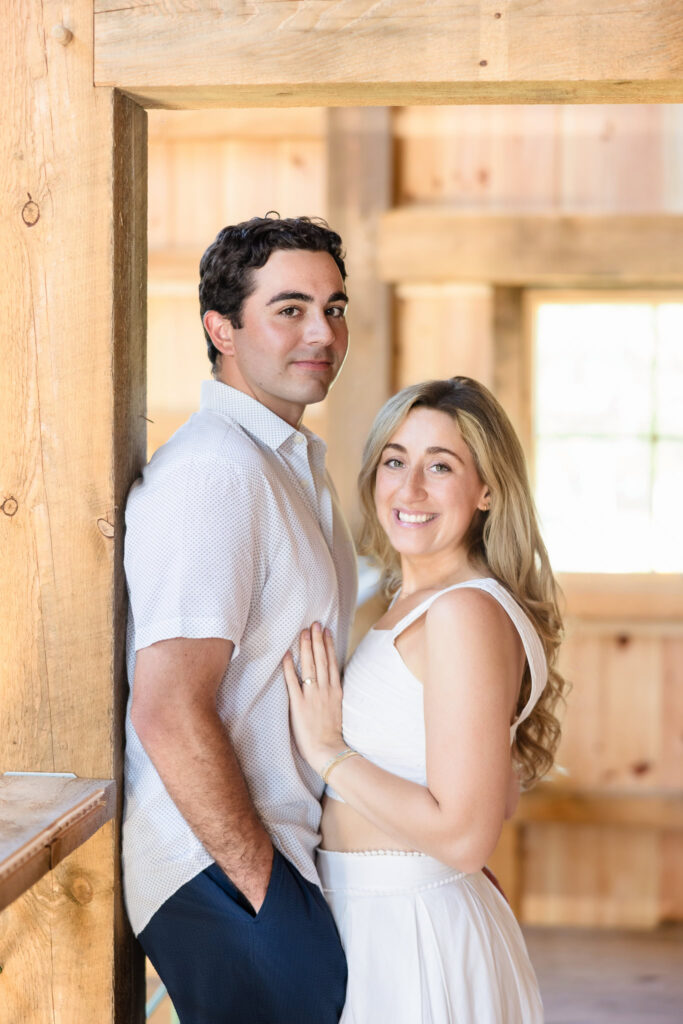 Kristen and James pose together in rustic wood interiors at Peeko Oysters.