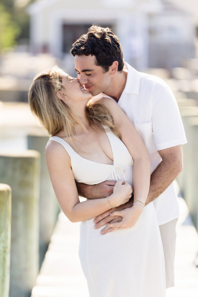 A spontaneous embrace and laughter on the dock, captured in golden light.