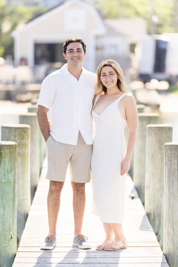 Kristen and James standing together with the marina behind them.
