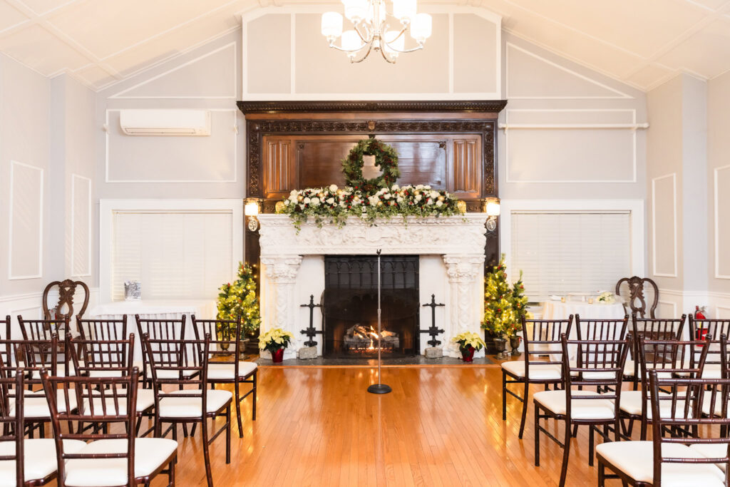 Ceremony space set in front of Stewart Manor’s white fireplace, styled with florals and soft natural light.