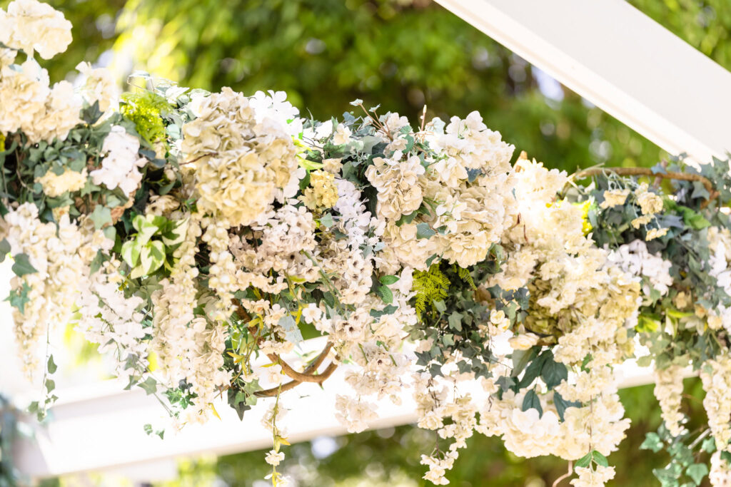 Lush floral arrangements on ceremony arch