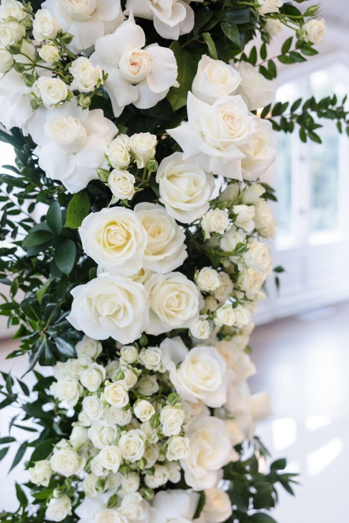 Elegant white rose floral installation at Whitby Castle wedding