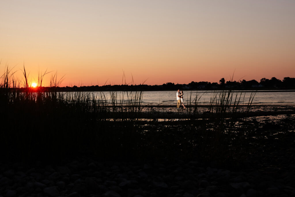 Sunset over Long Island Sound with tall grasses in the foreground at Greenwich Point Park.