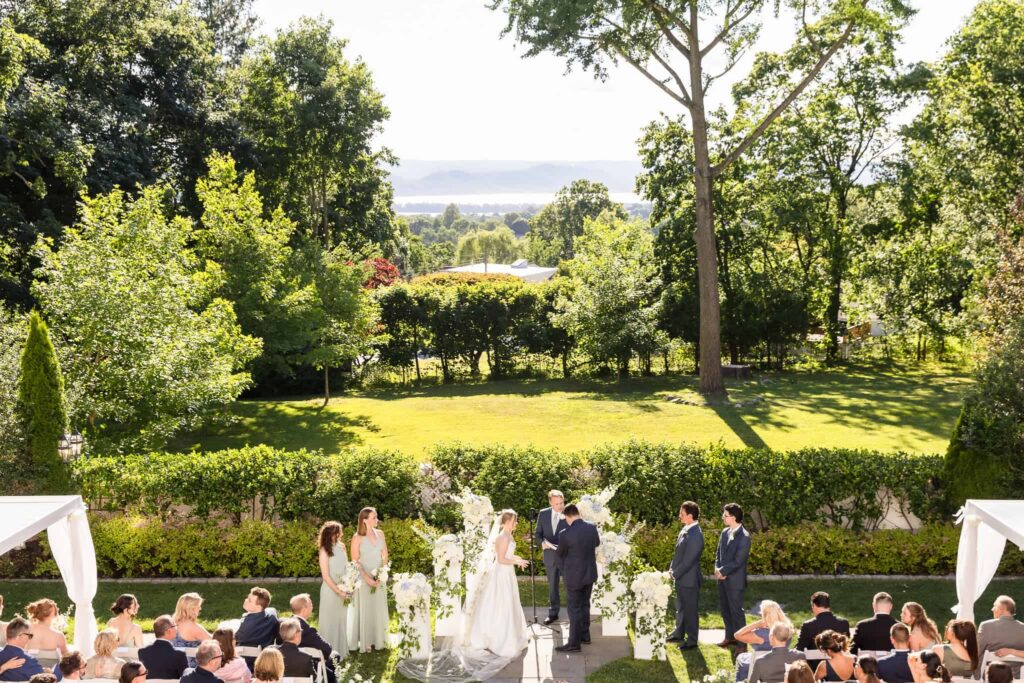 Outdoor wedding ceremony overlooking the landscaped grounds at Watermill Caterers on Long Island.