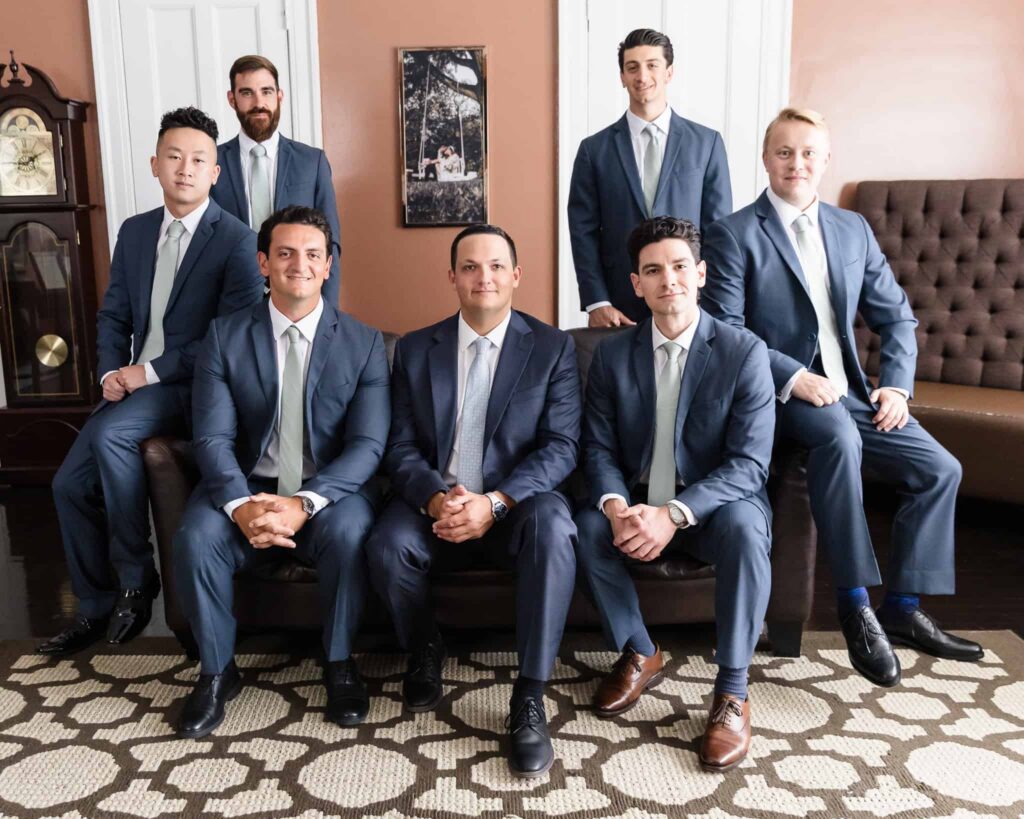 Groom and groomsmen posing together before the ceremony at Watermill Caterers in Smithtown.