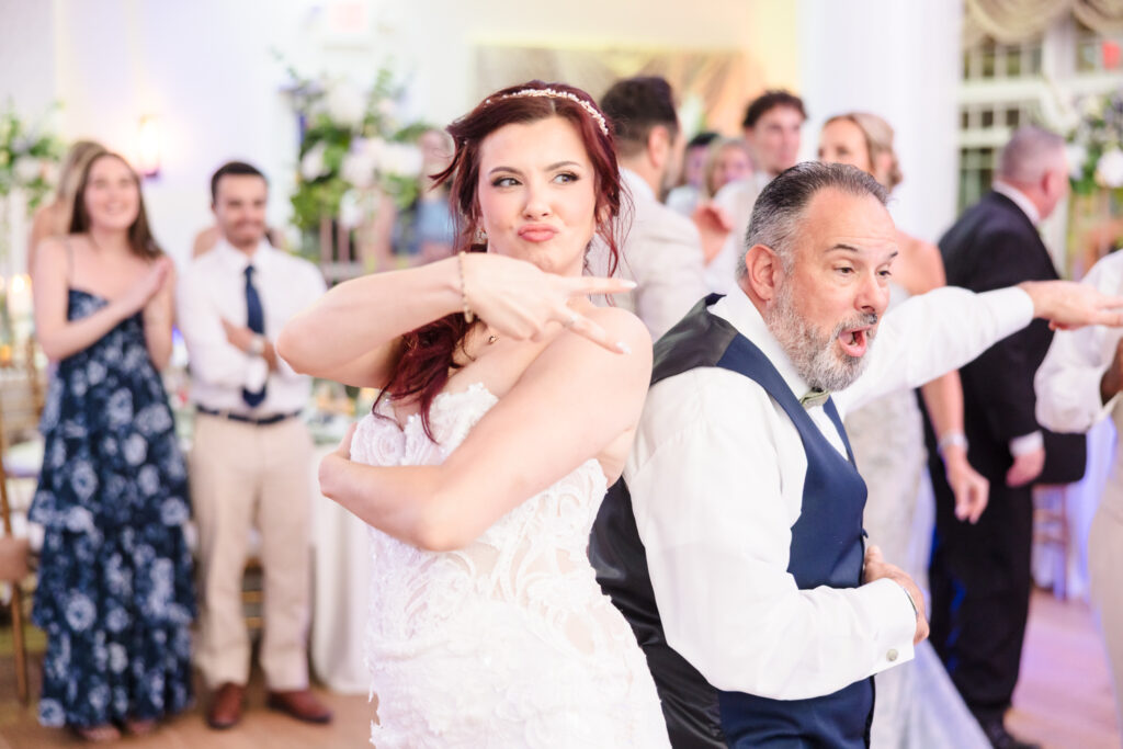 Bride dancing with her father during a lively choreographed moment at their Camp Pa-Qua-Tuck wedding reception.