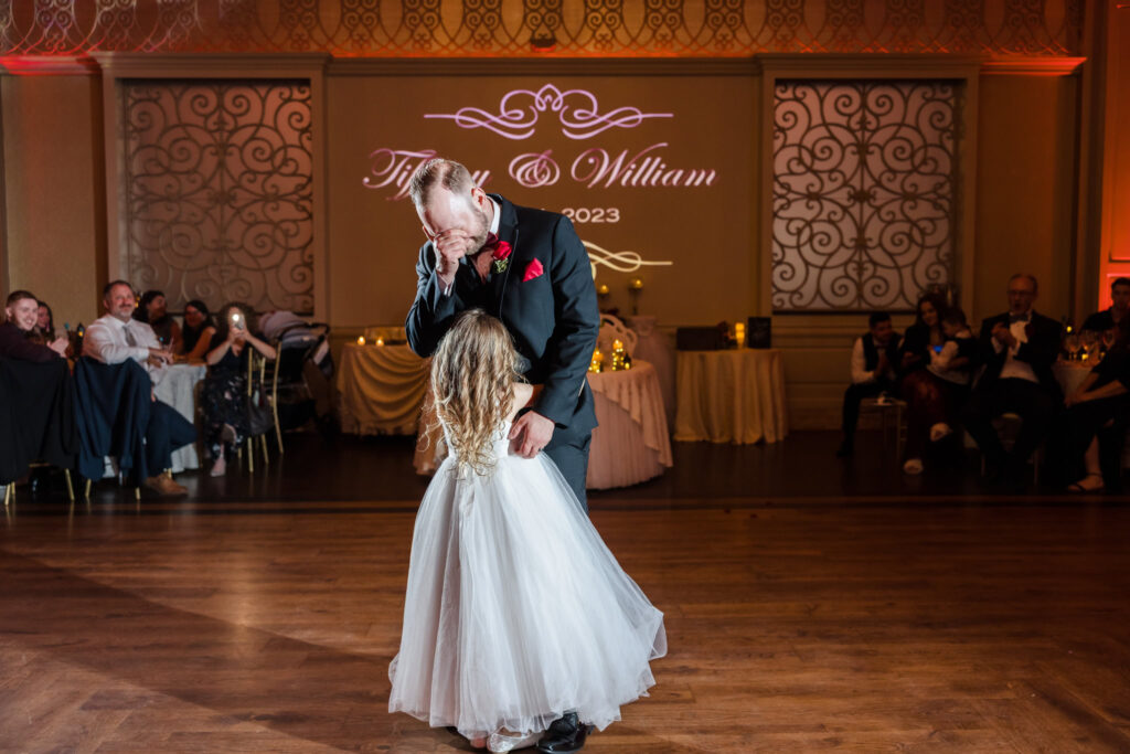 Emotional moment as the groom dances with his daughter during the wedding reception at Larkfield Manor, surrounded by family and guests in East Northport, Long Island.