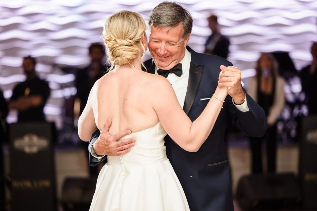 Bride shares a heartfelt father-daughter dance during her Crescent Beach Club September wedding reception, a tender legacy moment in the glow of the Long Island evening.